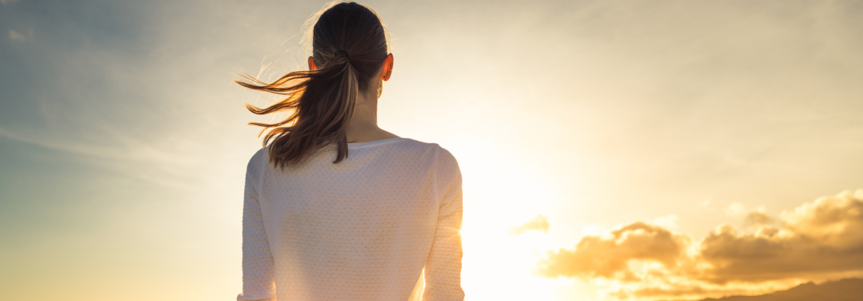 Woman watching beautiful sunset in Hawaii.