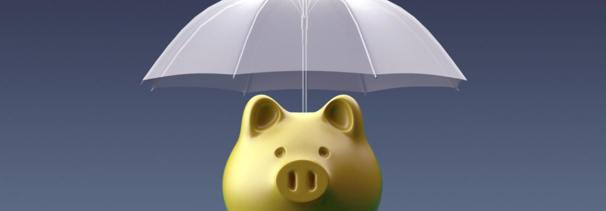 Umbrella is protecting a piggy bank on blue background.