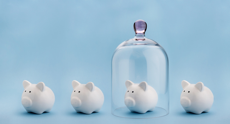 Piggybank protected under a glass dome on blue background